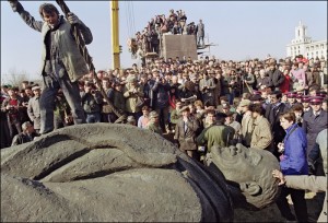 Lenin. A Romanian worker stands atop the statue, sculptur